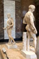 Classical Greek male nude marble statues at Louvre Museum. Paris, France.
