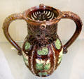 Glazed earthenware puzzle jug from Saintonge, France at Sèvres National Ceramic Museum. Paris, France.