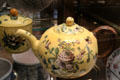 Ceramic teapot painted with flowers on yellow base by Joseph II Fauchier at Sèvres National Ceramic Museum. Paris, France.