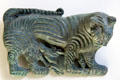Mongolian bronze plaque for belt showing tiger overpowering an ibex at Cernuschi Museum. Paris, France.