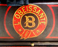 Detail of brand mark of L'Obéissante steam-powered omnibus by Amédée Bollée at Arts et Metiers Museum. Paris, France.