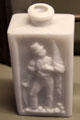 Molded white glass bottle with patriotic figure carrying flag & saber at Arts et Metiers Museum. Paris, France.