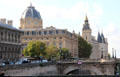 Domed Court of Commerce & Conciergerie with multiple towers on Ile de la Cité as viewed from Seine River. Paris, France
