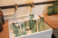 Preserve bottles in kitchen sink at Nissim de Camondo Museum. Paris, France.