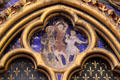 Painted biblical scene in Gothic tetrafoil surrounded by Fleur-de-Lys at St Chapelle. Paris, France
