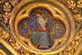 Painted biblical scene in Gothic tetrafoil surrounded by Fleur-de-Lys at St Chapelle. Paris, France.