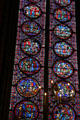 Stained glass with scenes of royal life at St Chapelle. Paris, France.