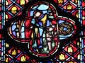 Angel with praying churchman in tetrafoil stained glass scene at St Chapelle. Paris, France.