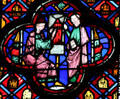 Saints with picture of tower stained glass scene at St Chapelle. Paris, France.
