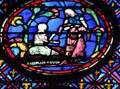 Man with woman over written caption stained glass scene at St Chapelle. Paris, France.