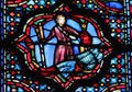 Man with decapitated head stained glass scene at St Chapelle. Paris, France.