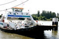 Ferry across Seine River coming into dock. Jumièges, France.