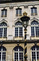 Lamp post with gilded design & National Opera of Lorraine with gilded ironwork balconies. Nancy, France.