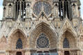 Rose window & three ornately carved front portals of Reims Cathedral. Reims, France.