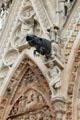 Rhinoceros gargoyle supported by male figure on Reims Cathedral. Reims, France.