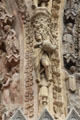 Detail of man pouring jug on portal carvings of Reims Cathedral. Reims, France.