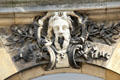 Stone carving of a face above entrance to Tau Palace Museum. Reims, France.