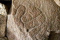 Neolithic design carved in stone inside funerary chamber of Merchants Table at Locmariaquer Megalithic site. Locmariaquer, France.