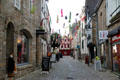 Shopping street festooned with decorative fish in historic center. Auray, France.