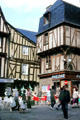 Half-timbered buildings over street activity. Vannes, France.