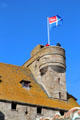 Château tower flying flag of Brittany. St Malo, France.