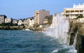 High waves crashing over sea wall of Digue du Rochebonne where many sea front hotels are located. St Malo, France.