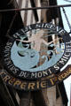 Sign with mermaid advertising souvenir shop & créperie along Grande Rue. Mont-St-Michel, France.