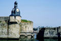 Clock tower on stone walls of old town. Concarneau, France.