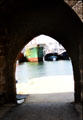 View of port & fishing boat through old town gate. Concarneau, France.