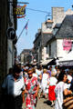 Narrow street in old town crowded with visitors. Concarneau, France.