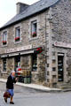 Stone building, in Brittany style, on St. Thégonnec shopping street. St Thégonnec, France.