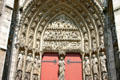 Gothic arch with crucifixion carving surrounded by saints over western portal of Rouen Cathedral. Rouen, France