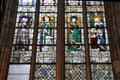 Stained glass windows by Guillaume Barbe of St Clare, a Bishop, St. Mary Magdalene, & St. Anne teaching the virgin at Rouen Cathedral. Rouen, France.