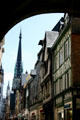 Cathedral spire beyond half-timbered buildings on rue du Gros Horloge. Rouen, France.