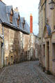 Narrow cobble stoned street in Angers old town. Angers, France.