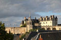 Buildings & flags of Chateau Royal of Amboise above town dwellings. Amboise, France.