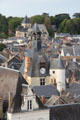 Clock tower & St. Denis church among roofs of old town. Amboise, France.
