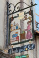 Ornamental wrought iron shop sign for Midi au Soleil. Amboise, France.