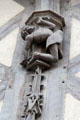 Carving detail of man in Medieval dress bending over backward on Acrobats house. Blois, France.