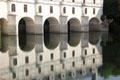 Chenonceau Chateau bridge reflected in River Cher. Chenonceau, France.