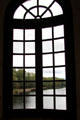 View of Cher River through Gallery window at Chenonceau Chateau. Chenonceau, France.