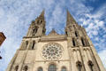 Gothic & Romanesque bell towers with rose window in between at Chartres Cathedral. Chartres, France.