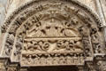 Arched doorway tympanum carved with symbols of Christ at Chartres Cathedral. Chartres, France.