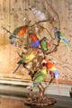 Branch with 8 porcelain parrots upstairs at Cheverny Chateau. Cheverny, France.