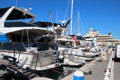 Pleasure craft moored at Old Port & mega yacht at restricted dock. Antibes, France.
