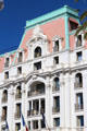 Ornate roof line & balcony railings on Hotel Le Negresco on Promenade des Anglais. Nice, France.