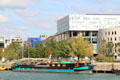 River houseboat with Novotel & modern architecture of Confluence district. Lyon, France.