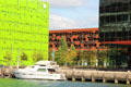 Green Euronews building & red Mob Hotel in Confluence district. Lyon, France.