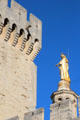 Papal Palace tower & gilded statue of Mary atop Avignon Cathedral. Avignon, France.