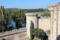 Ramparts of Avignon with octagonal tower against Rhone River. Avignon, France.